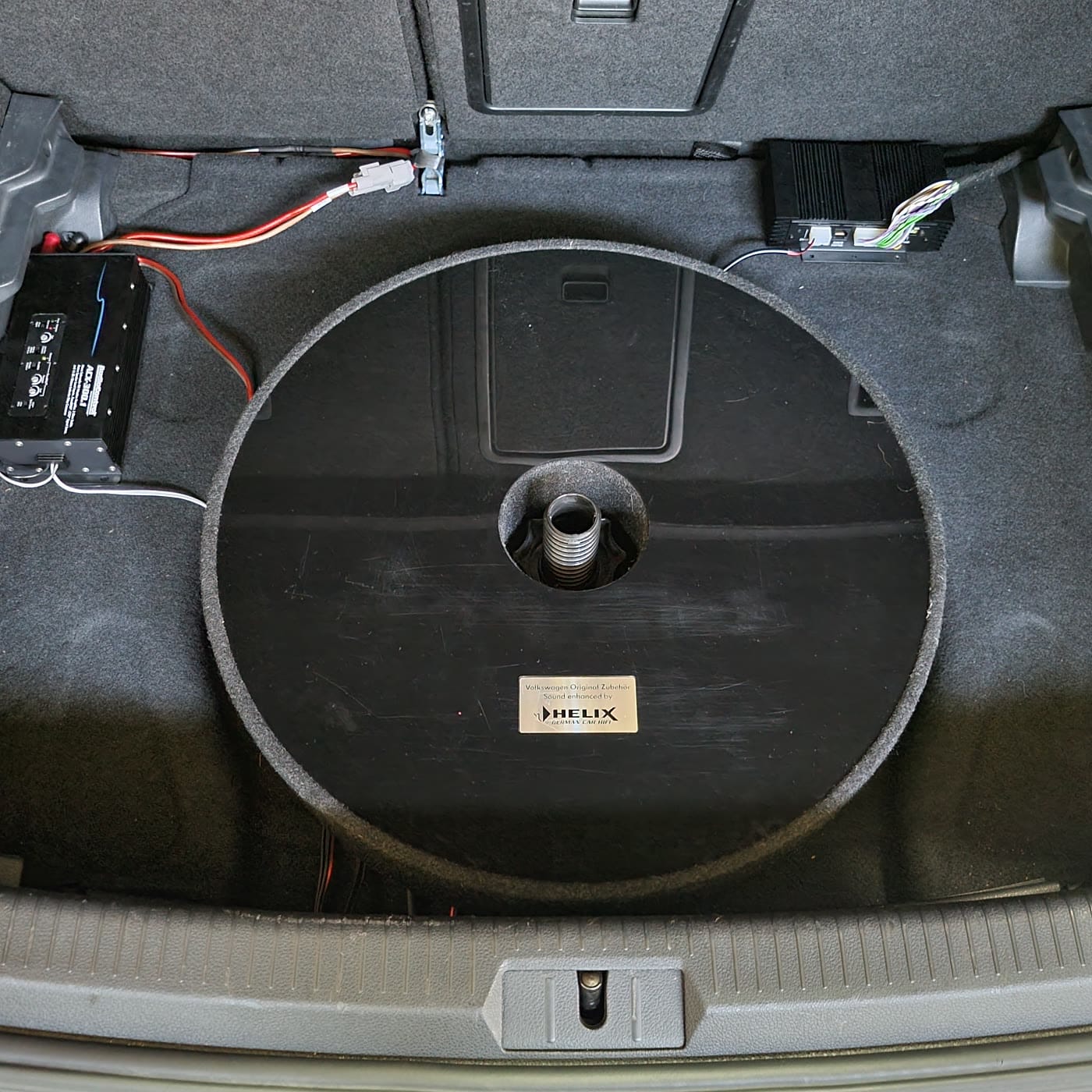 Completed install in the spare tire well with ACX amp and Helix DSP visible